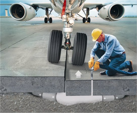 Construction worker lifting an airport slab.